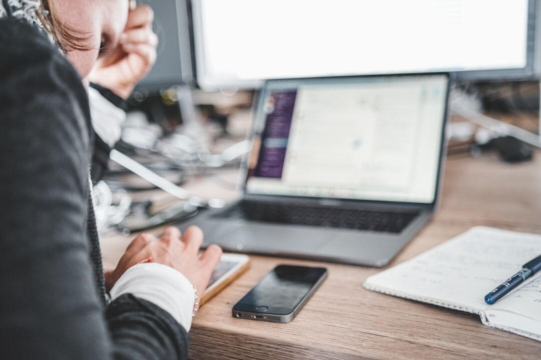 Business professional analyzing charts on a laptop at a desk